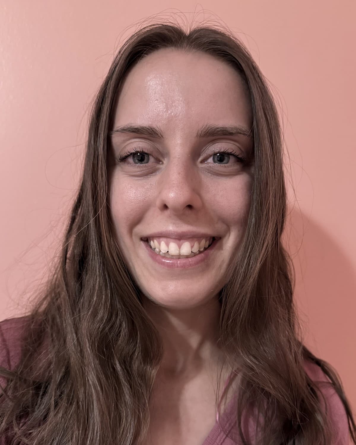 The stylist behind Styled and Sparkled, smiling, with long brown hair worn loose.